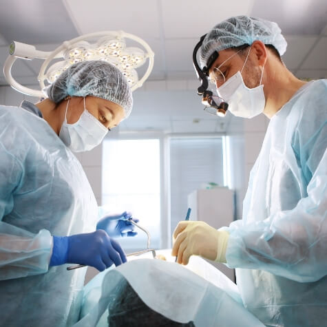 Dentist and team member treating dental patient