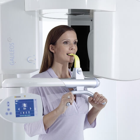 Dental patient receiving 3 D cone beam imaging scans