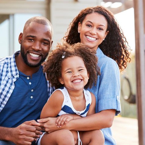 Portrait of happy family with mother, father, and daughter 