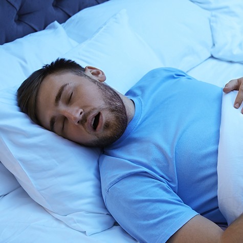 Man snoring in bed