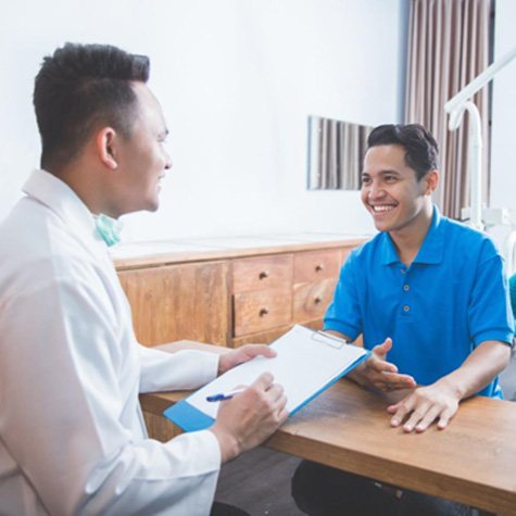 Dentist and patient discussing treatment options for adult orthodontia