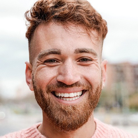 a man smiling with a dental bridge in McKinney