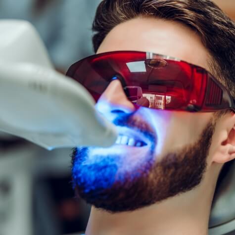 Patient receiving in office teeth whitening treatment