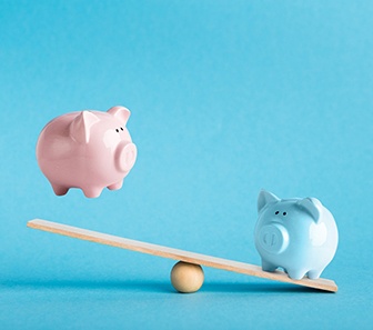 Piggy banks on balance scale