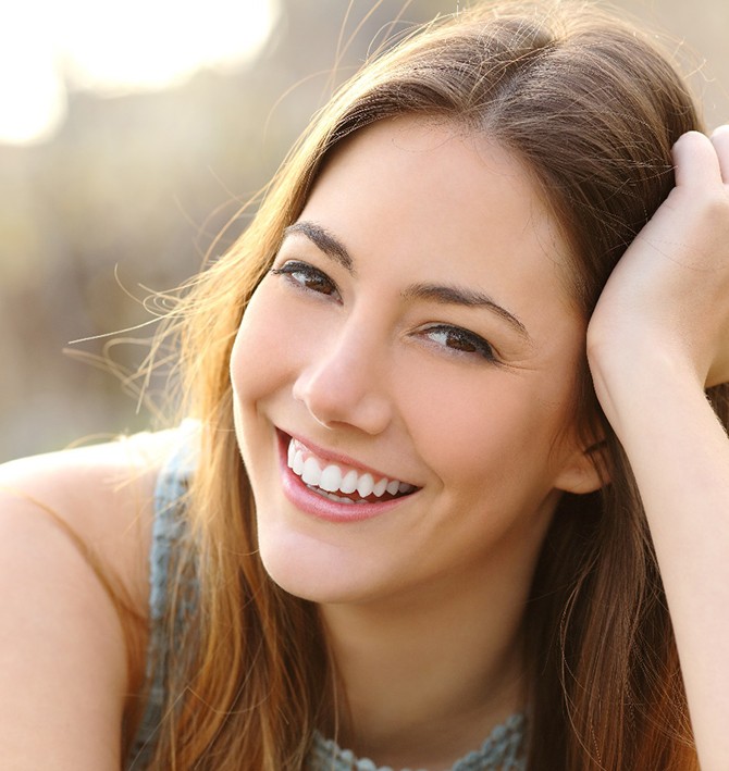 woman smiling after getting dental crowns in McKinney