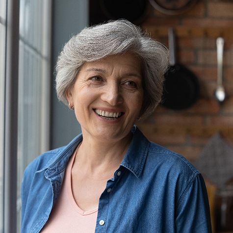 a woman smiling with dentures in McKinney