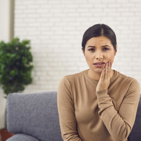 Woman in pain before wisdom tooth extraction