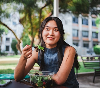 Patient in McKinney eating with dental implants