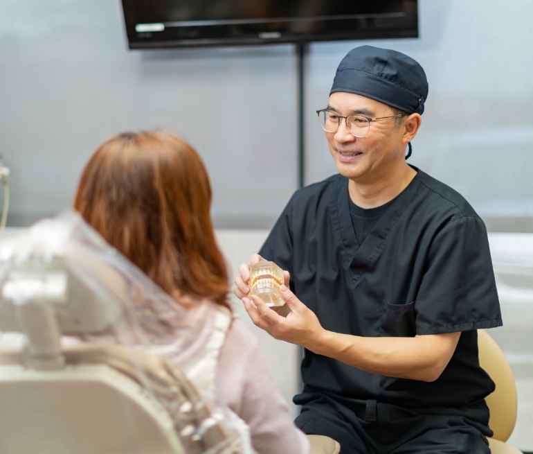 McKinney Texas dentist showing a dental patient a model of the teeth