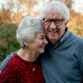 Senior man and woman laughing together outdoors