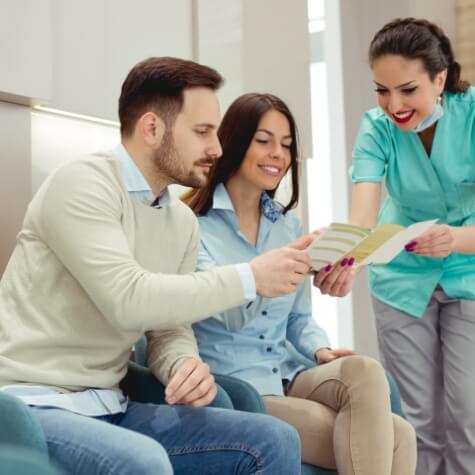 Dental patients reviewing dental insurance information with team member