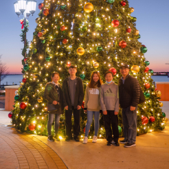 Doctor Cha and his family in front of Christmas tree