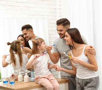 Family brushing their teeth