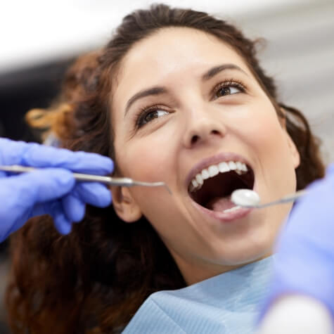 Woman receiving dental checkup and teeth cleaning