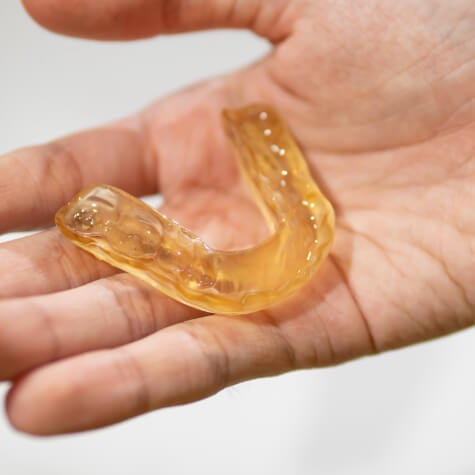 Person holding nightguard for bruxism
