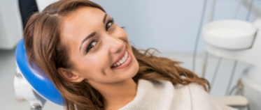 Woman sharing healthy smile during preventive dentistry visit