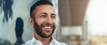 Man sharing perfected smile after orthodontic treatment