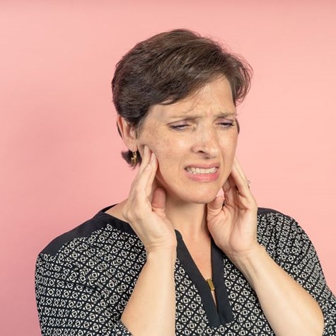 Woman struggling with TMJ pain
