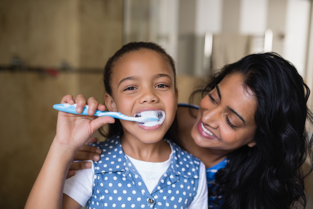 child brushing teeth during cold and flu season