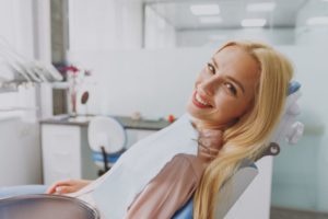 Happy dental patient reclining in treatment chair