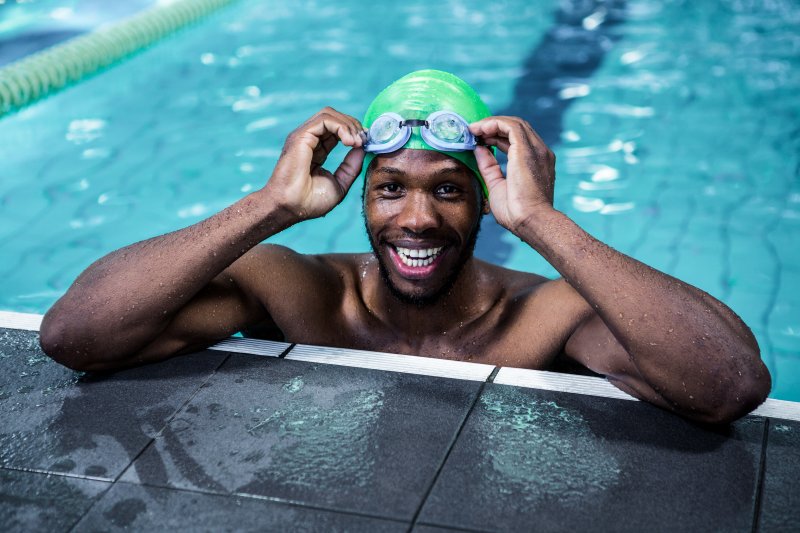 Patient smiling in the pool after teeth whitening