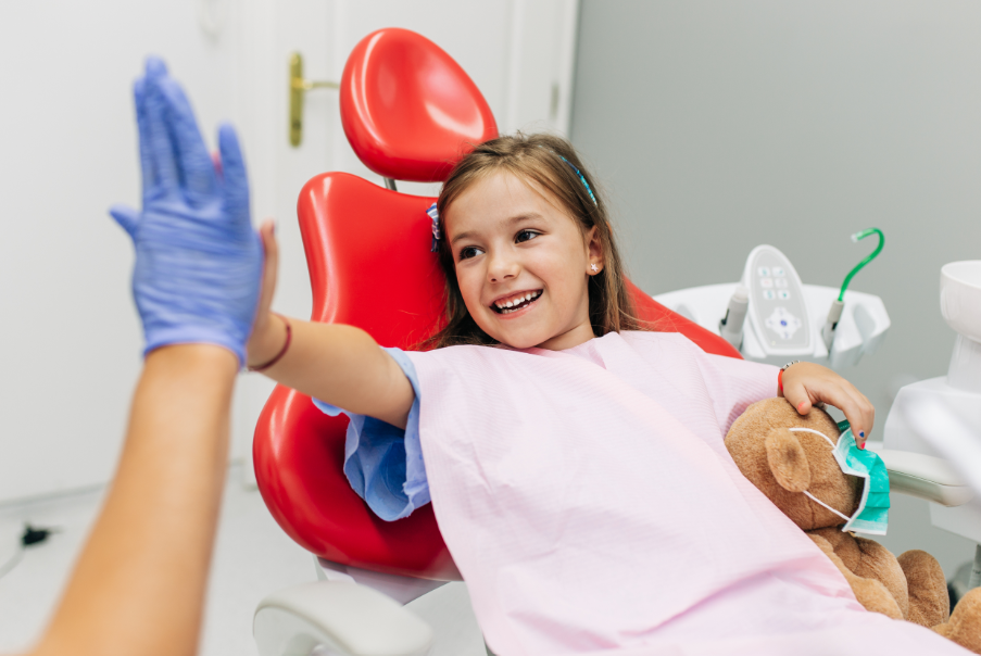 Child high fiving dentist